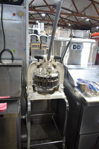 Dutchess BM58 manual dough divider on casters, floor style, good condition, visible lever mechanism, commercial kitchen setting.