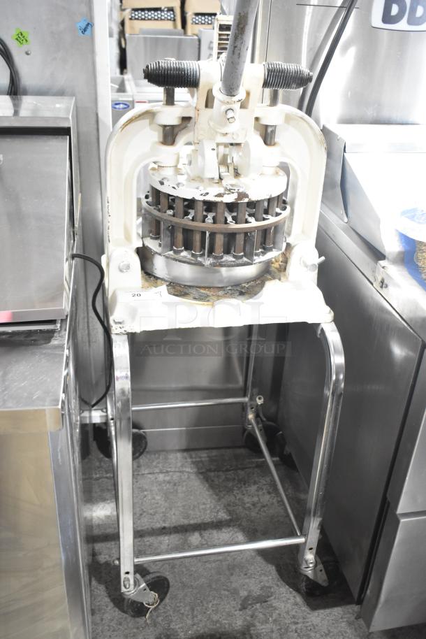 Dutchess BM58 manual dough divider on commercial casters, metal frame, used condition, model number visible.
