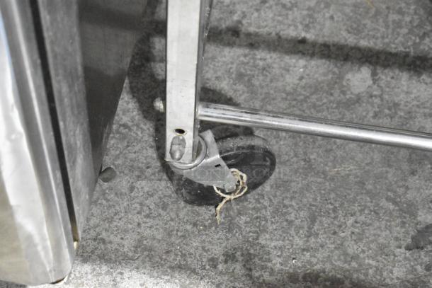 Dutchess BM58 dough divider on commercial casters, metal frame shown on concrete floor, good condition.