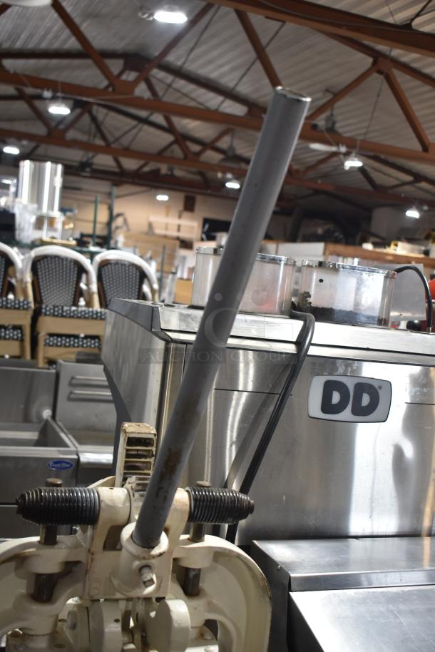 Dutchess BM58 commercial dough divider, manual floor style, on casters, visible DD logo, industrial setting.