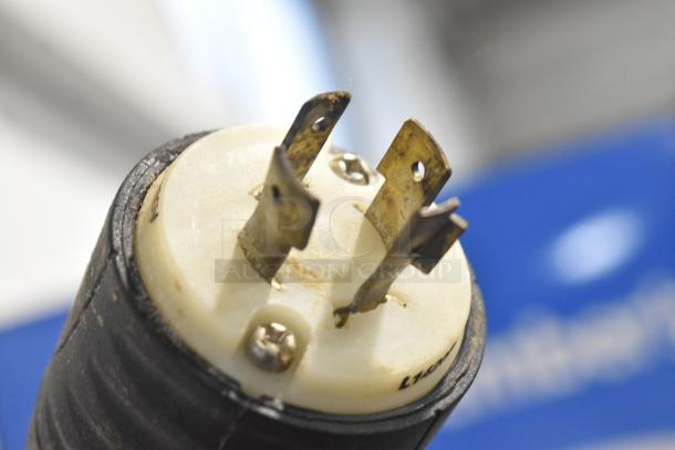 Close-up of a three-prong plug for the Hobart P660 commercial mixer, showing metal prongs and a white plastic base.