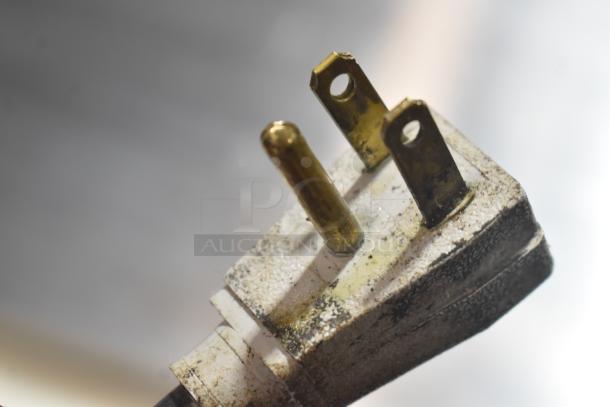 Close-up of a three-prong electrical plug from the 2019 True TSSU-60-16D-2-HC prep table.