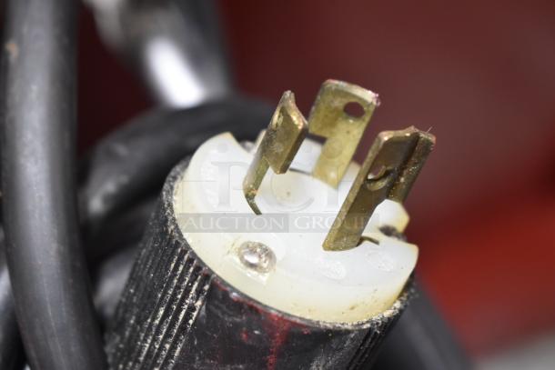 Close-up of a plug from a Hobart M802 commercial dough mixer. Three-pronged, showing wear. For 230 volts, 1 phase.