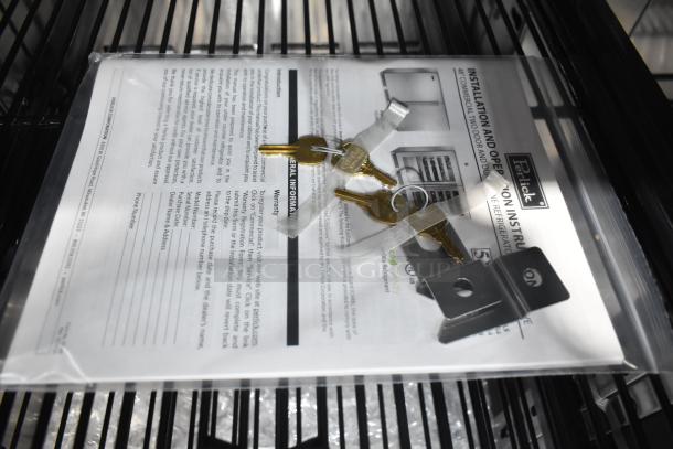 Perlick HC48RS4S-00 Back Bar Cooler paperwork with keys and installation instructions visible on a shelf.