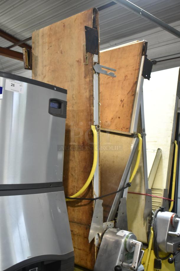 Rondo Seewer commercial floor-style reversible dough sheeter, metal frame, visible wear on wooden boards, industrial use.