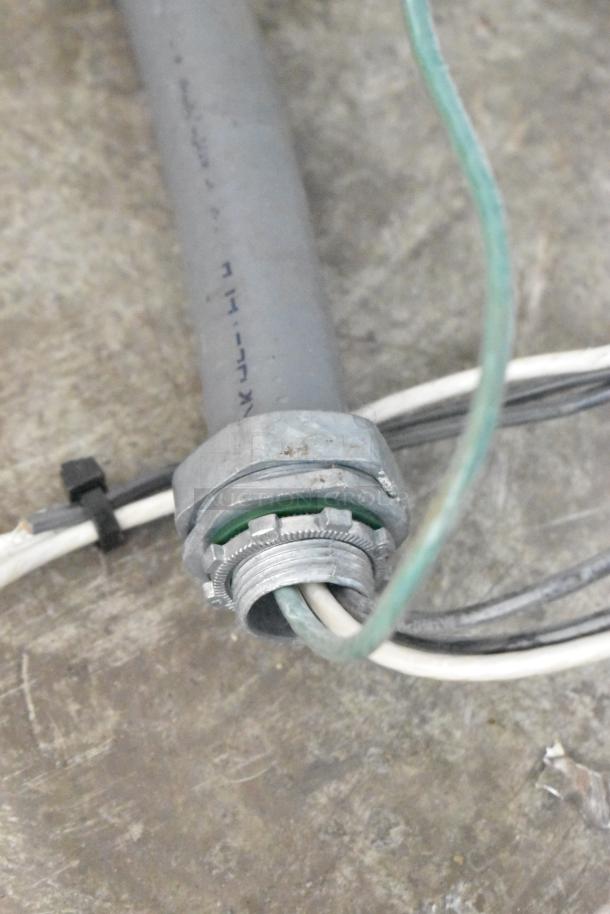 Close-up of the wiring and conduit connection related to a Groen TDB-20 Commercial 20 Quart Tilting Steam Kettle.