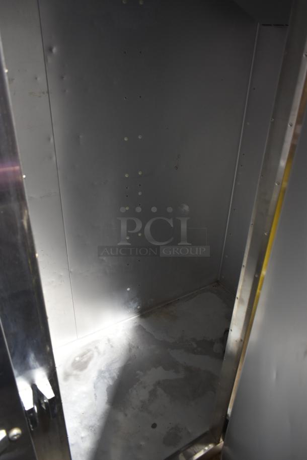 Traulsen G31010 Commercial 3 Door Freezer interior, stainless steel. 115 Volts, 1 Phase, sturdy construction, ready for use.