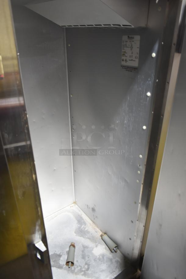 Traulsen G31010 commercial 3-door reach-in freezer interior. Model label visible. Some wear, 115 volts, 1 phase.