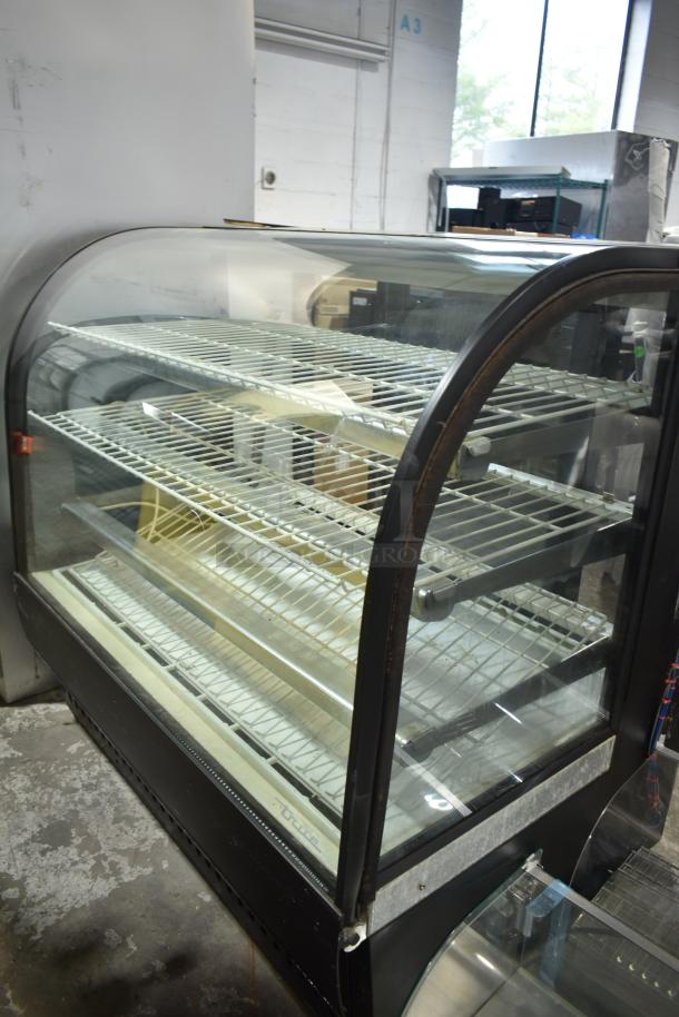 True TCGR-50 refrigerated display case, commercial floor style, 115 volts, tempered glass, multiple shelves, used condition.