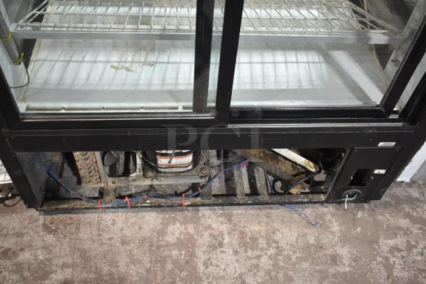 True TCGR-50 refrigerated display case, features dual sliding glass doors; visible internal wiring, 115 volts, 1 phase.