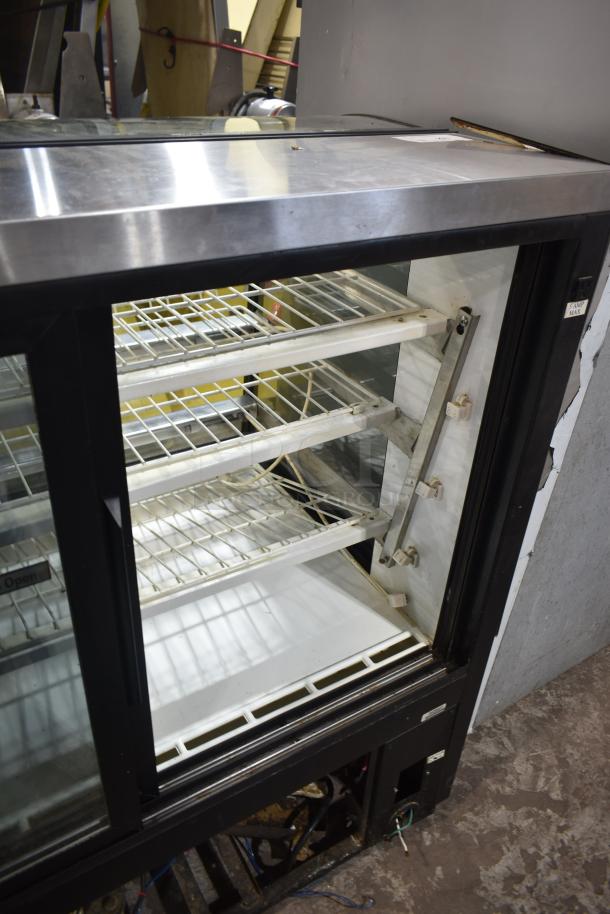 True TCGR-50 Commercial Refrigerated Display Case, floor style, stainless steel top, glass front, three shelves, 115V, 1 phase.