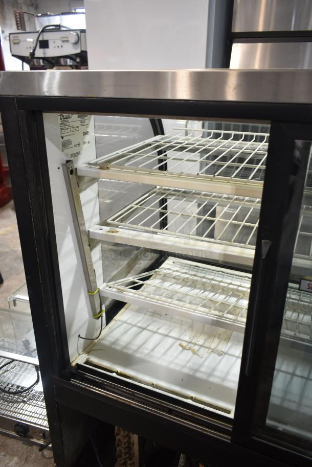 True TCGR-50 refrigerated display case, commercial floor model. Features 115 volts, 1 phase, visible shelving, labels.