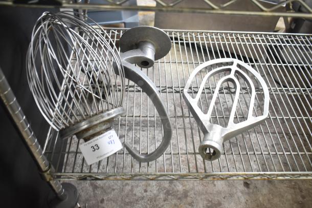 3 Hobart mixer attachments: whisk, paddle, and dough hook. Metal, lightly used, with visible auction tag reading "33, Qty x3."