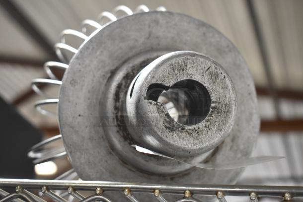 Three Hobart mixer attachments: whisk, paddle, and dough hook, showing signs of use; bid includes all three.