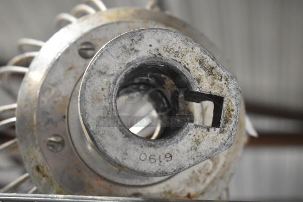 Close-up of Hobart mixer attachments showing metal construction and markings. Includes 60 quart whisk, 60 quart paddle, and 80 quart paddle.