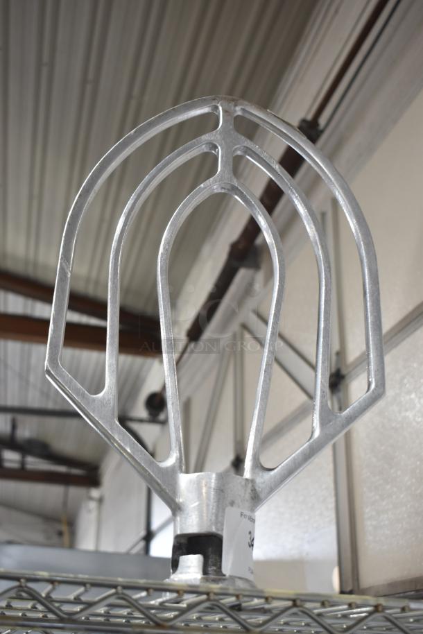 Three Hobart mixer attachments including a 60-quart whisk, 60-quart paddle, and 80-quart paddle, in good condition.