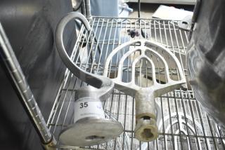 Two Hobart mixer attachments: dough hook and 30-quart paddle, silver tone, used condition, on wire rack with auction label.