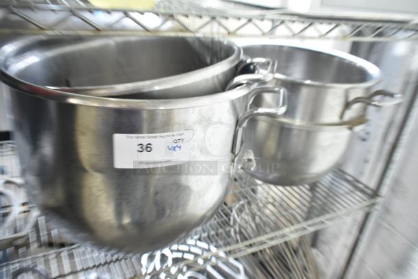 Three Hobart mixer bowls, including D30 30-quart and VMLH-40 40-quart, in stainless steel, on a shelf with auction label.