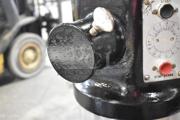 Hobart L800 commercial 80-quart dough mixer detail showing control panel, featuring start/stop buttons and speed dial.