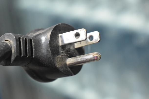 Power plug for Crane 5800-4 vending machine, 115 volts, 1 phase. Black plastic, close-up view.