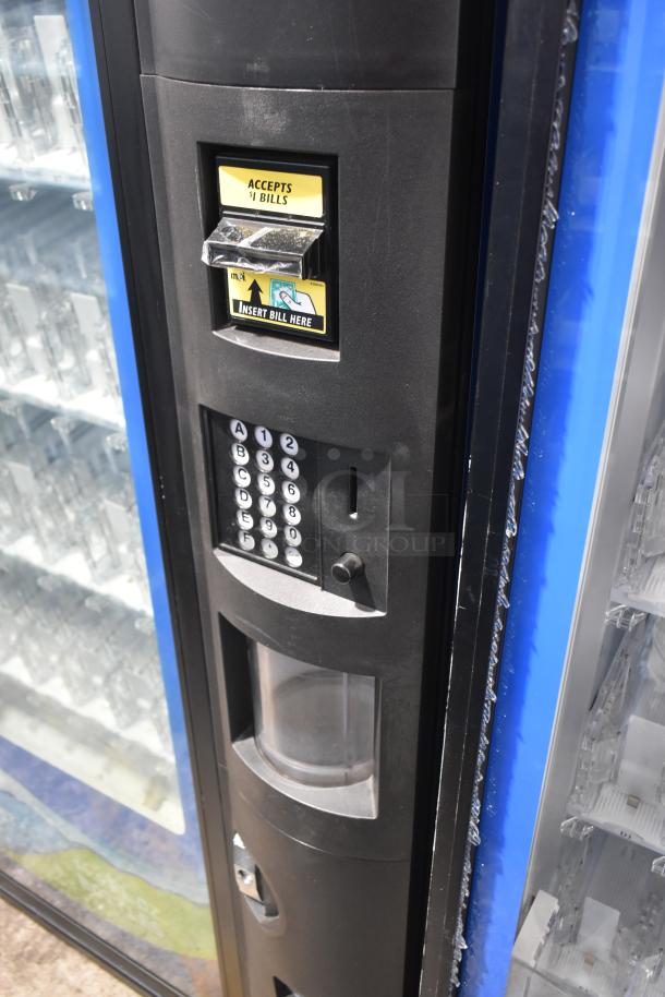 Crane 5800-4 metal vending machine with bill acceptor, keypad, and glass display. Used condition. 115 volts, 1 phase.