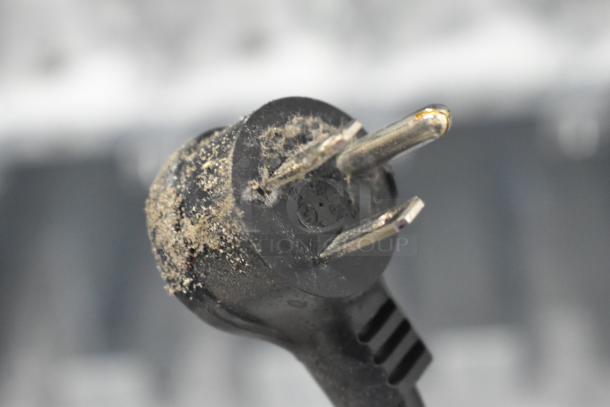 Close-up of a dusty power plug from a Crane 5800-4 vending machine. Plug shows signs of wear.