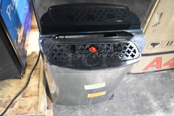 Avalon A4BLWTRCLR water dispenser, bottom loading, 120V, 1 phase, visible tags, slight wear, sturdy black and silver design.