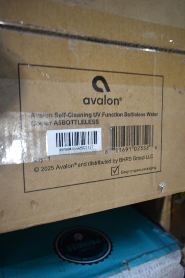 Two Avalon water coolers in box: A4BLWTRCLR bottom-loading, A5BOTTLELESS bottleless, 120V, 1 phase. Boxes show Avalon branding and serial numbers.