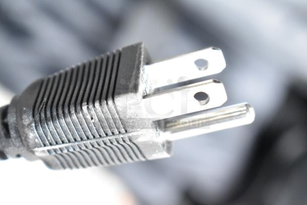 Close-up of a black three-prong electrical plug, associated with water dispensers. Suitable for 120 volts, 1 phase.