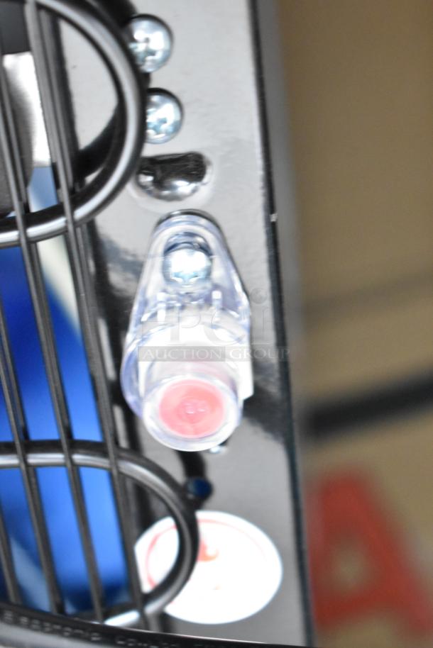 Close-up of water cooler component with screws and tubes visible, showcasing part of the Avalon A23F bottom loading water dispenser.