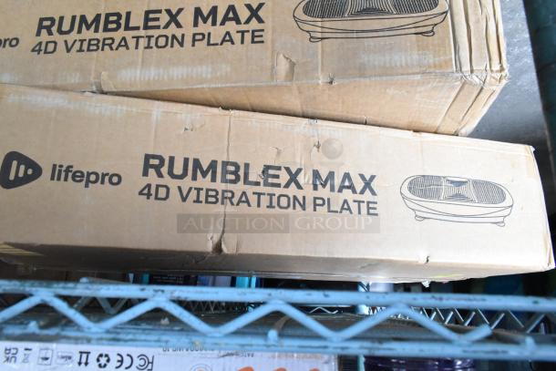 Two LifePro Rumblex Max 4D Vibration Plates in boxes, labeled as new, with visible packaging wear.