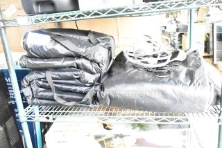 Three LifePro LP-BRMDYL-BLK-1 sauna blankets in black, 110 volts, 1 phase, neatly folded on a shelf with cables.