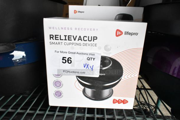 LifePro Relievacup Smart Cupping Device in box, part of auction lot with red light therapy, massage ball, and massager.