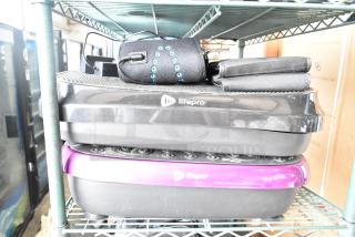 Four items including two LifePro vibrating plates, black and purple, with control panels. Good condition.