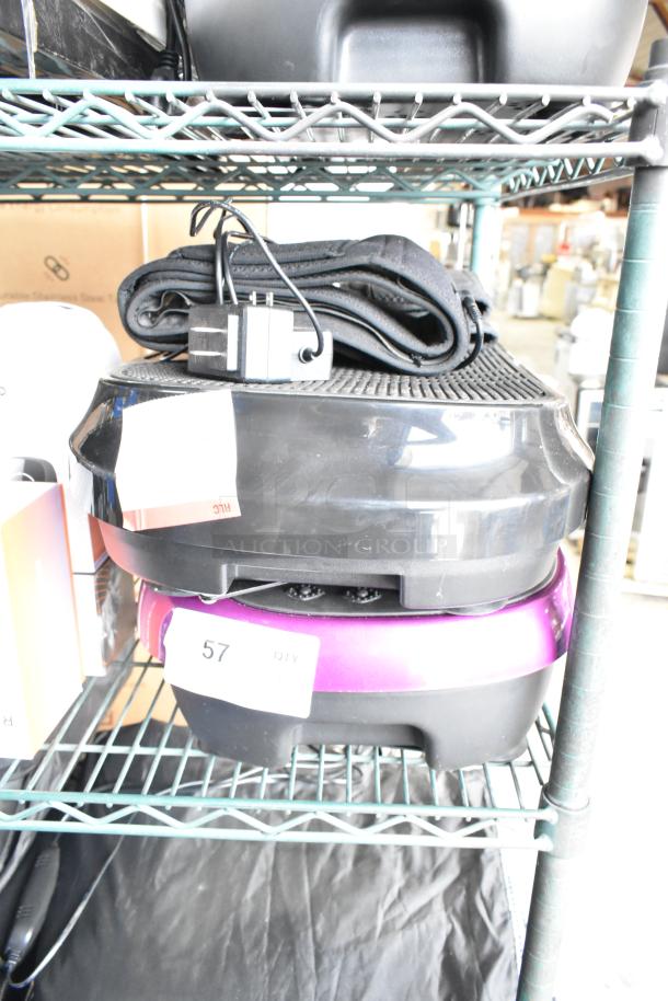 Four items including two LifePro vibrating plates, stacked on a shelf. Visible power cords and tags marked "57".