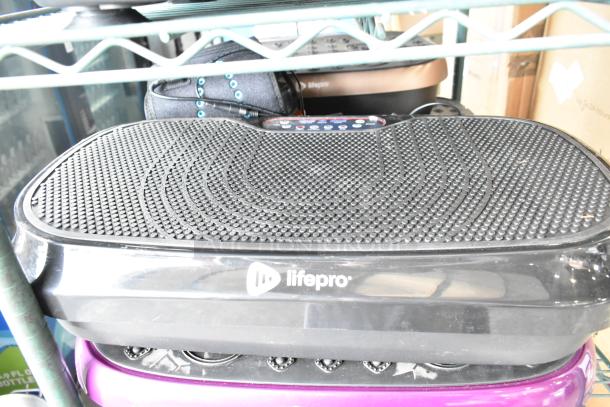 Two LifePro vibrating plates in good condition, black and purple, noted for effective workout enhancement.