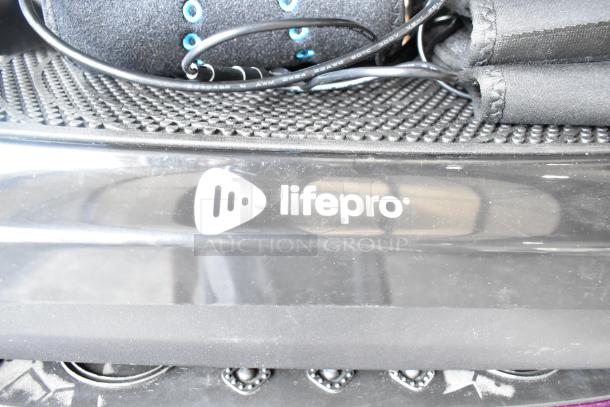 LifePro vibrating plate with visible logo, textured surface, and attached cables. Features part of a set of four items.
