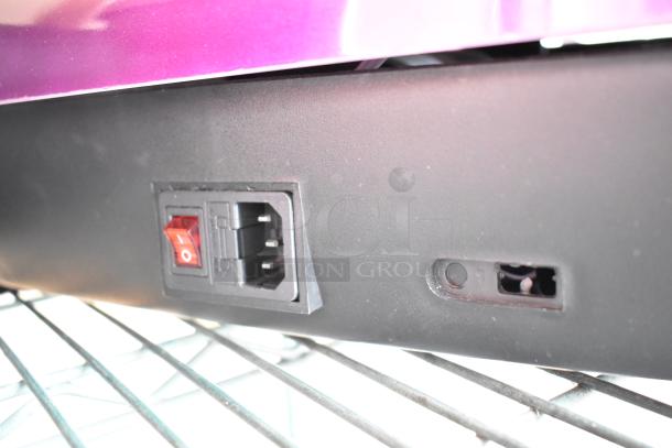 Power switch and plug socket on black LifePro vibrating plate. Visible are a red rocker switch and power port, indicating operational status.