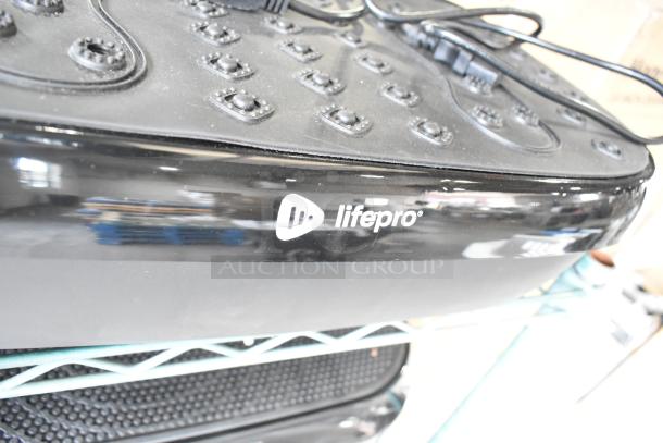 LifePro vibration plate in black, featuring a textured surface and power cord. Brand logo "lifepro" is visible.