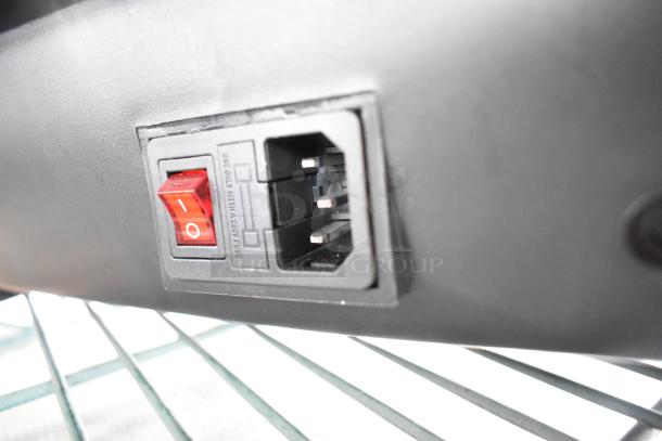 Close-up of a power switch on a device. Red toggle labeled "I/O," next to power socket. Text: "Use only with a 250V fuse."