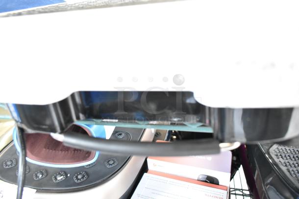 Four items including Hurtle HURVBTR36 Vibration Plate, LifePro Vibration Plates, Chefman RJ58-EM-MIDNIGHT-AM-E Pizza Maker, Harman Kardon Speaker, placed on a shelf.