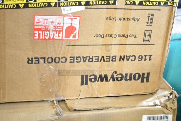 Box for Honeywell H115BCS 115 Can Cooler. Visible "Fragile" and "Caution" labels. Box shows signs of handling.