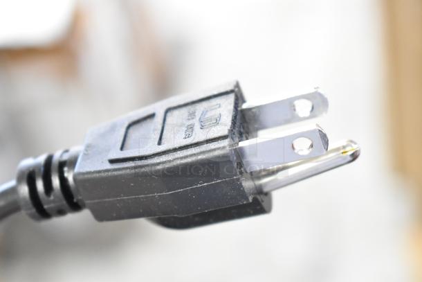 Close-up of a power plug for a LifePro WVR 1010 Vibration Plate; shows standard prongs and black casing.