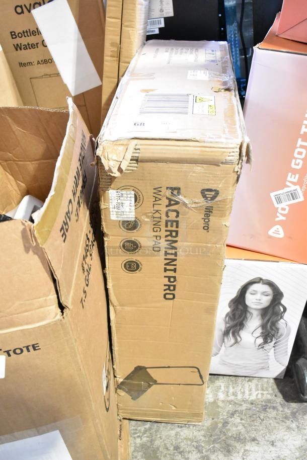 Brand new LifePro Pacer Mini Pro Walking Pad box, showing scratch and dent damage.