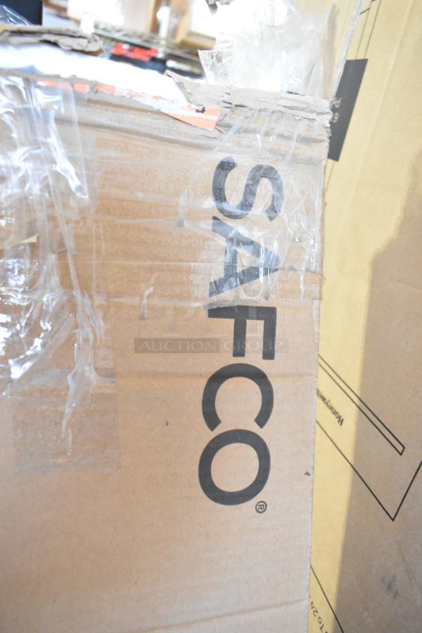 Cardboard box labeled "SAFCO" containing scratch and dent Safco 4163BL 21"x21"x70" black metal coat rack, 4 double hooks.