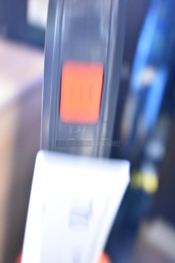 Blurred close-up of Hoover CH53010 vacuum cleaner with a visible red switch and partially visible label.