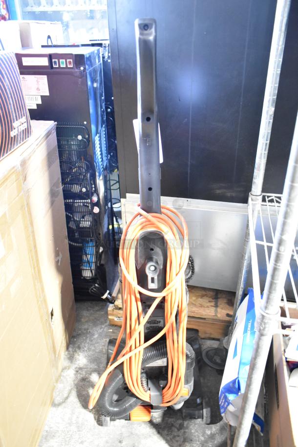 Hoover CH53010 Vacuum Cleaner, upright model with orange cord, 120 volts, used condition, visible scrubbing brush, 1 phase.