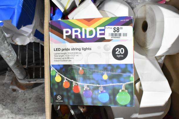 Box of LED pride string lights with 20 bulbs, 15.8 ft lighted length. Price tag shows $8.99.