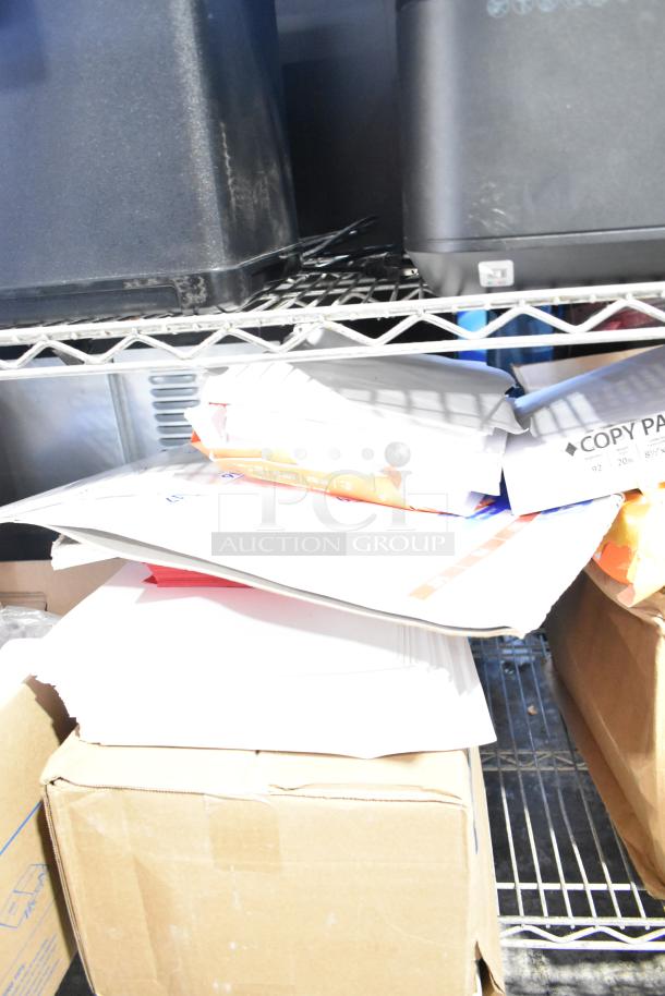 Tier lot with Pride string lights, light-up bracelets, exam table paper, and file folders on metal shelving.