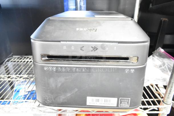 Fellowes Powershred LX180 black cross-cut shredder, slightly worn, features icons on front, clearance label at bottom.